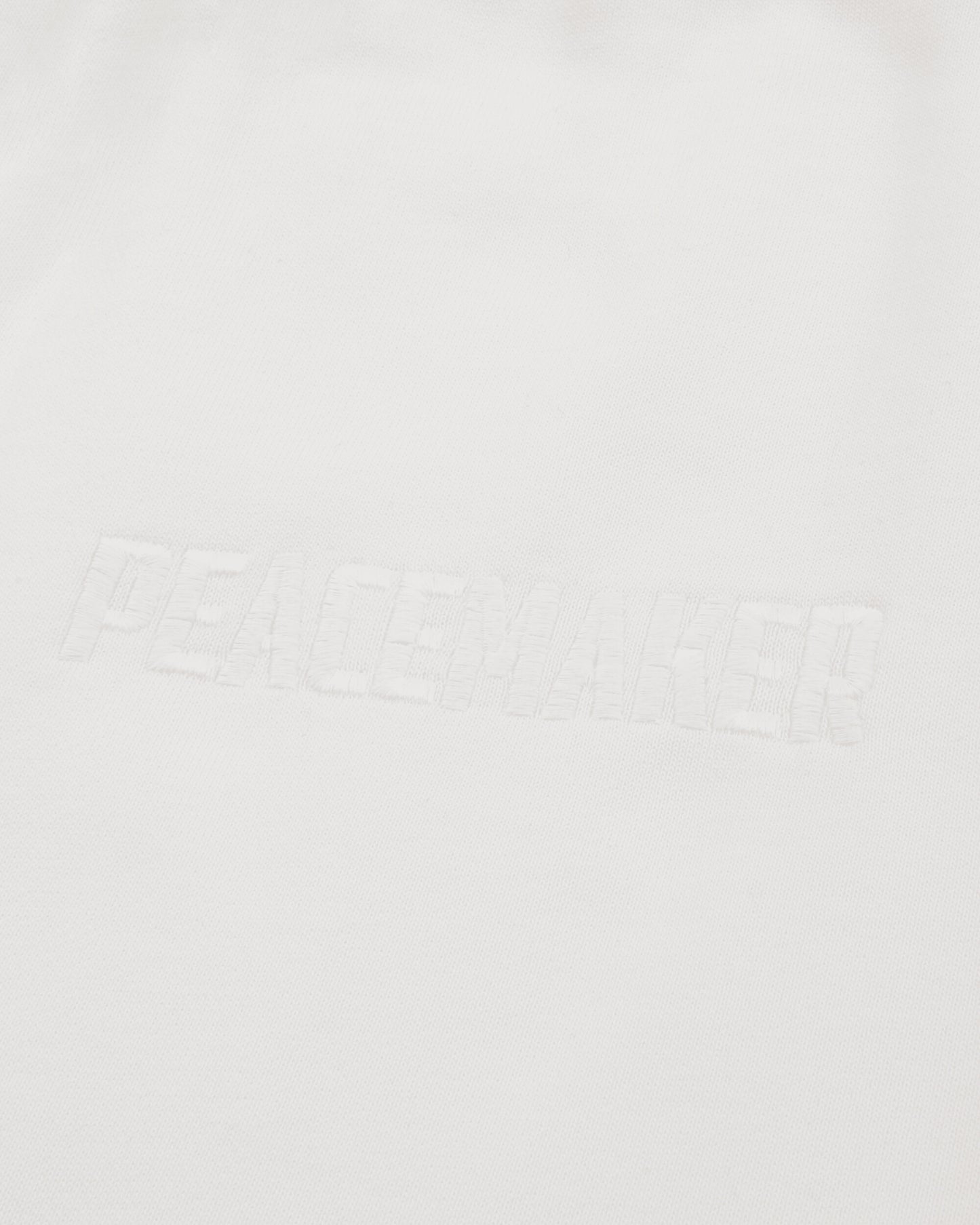 OAMC Peacemaker Loose Fit Sweatpants Peacemaker Logo White Pants Sweatpants PCM2OW01PFT00201 01